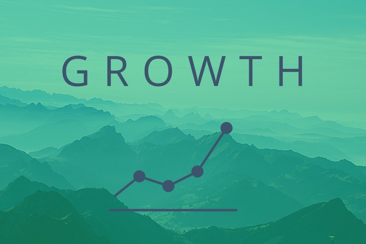 Mountains in shades of teal fill the image behind the word "GROWTH," which is seated above a linear growth expression, illustrating the way our Little Rock digital marketing agency can affect your business.