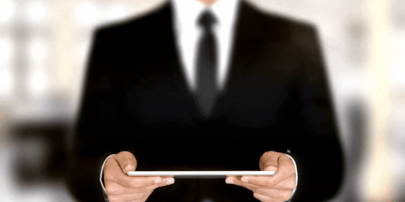 Content marketing is one of the most essential parts of digital marketing Little Rock businesses need. A man in a suit holds a tablet that creates a hologram with the words
