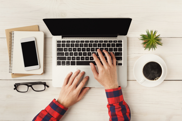 Man's hands typing on laptop