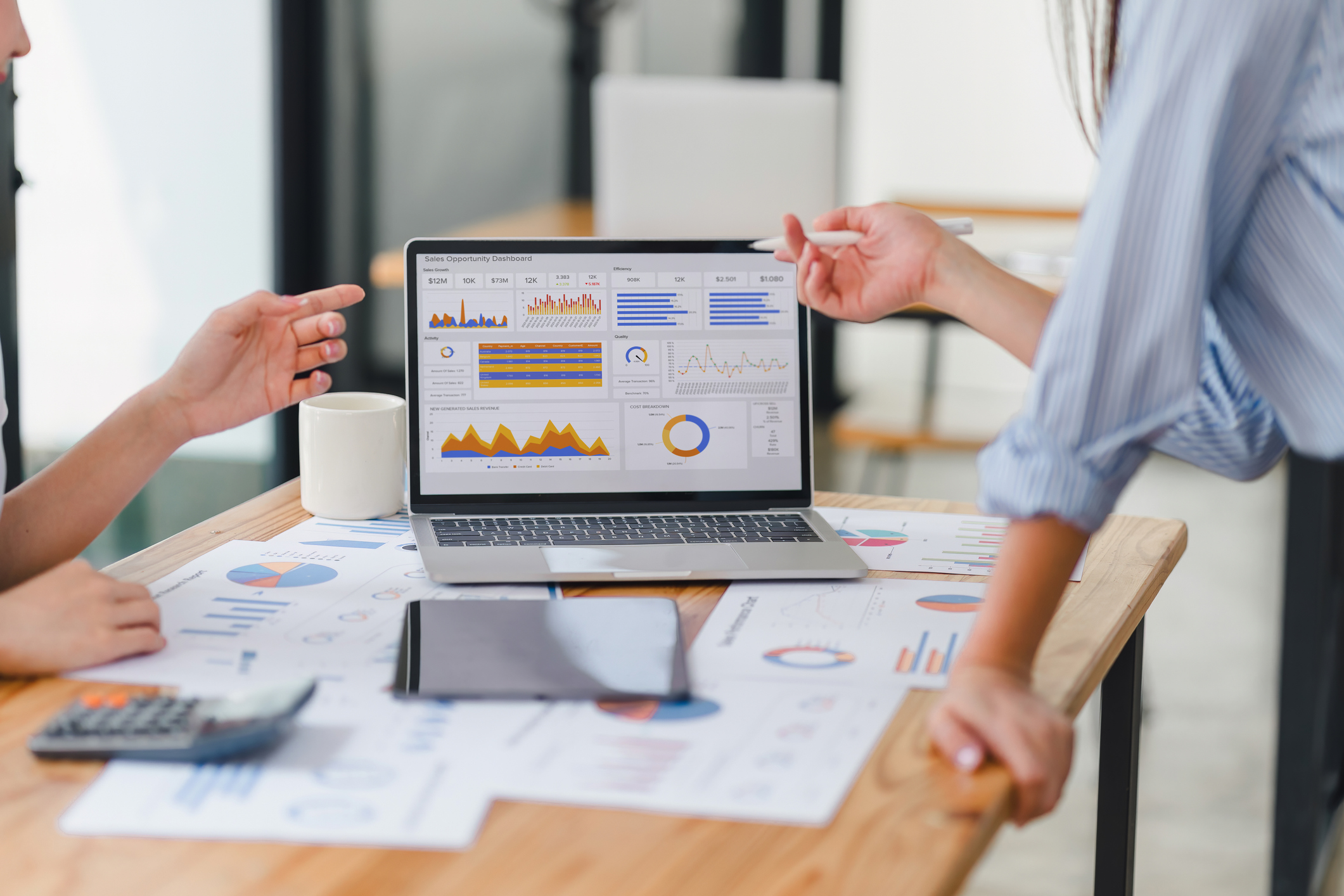 Two people working on data analysis dashboard for business strategy